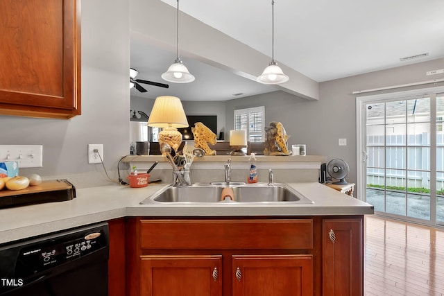 kitchen with a peninsula, a sink, visible vents, black dishwasher, and light countertops