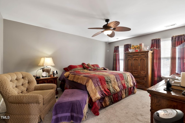 carpeted bedroom featuring visible vents and ceiling fan