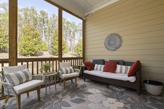 sunroom featuring beam ceiling