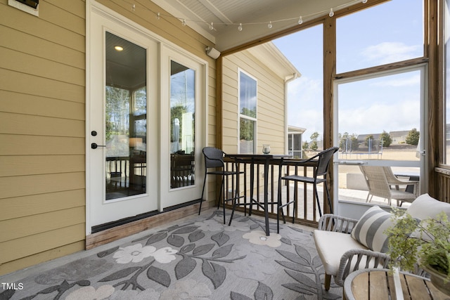 sunroom featuring track lighting