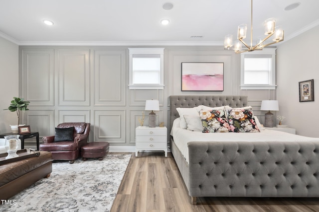 bedroom featuring a chandelier, recessed lighting, wood finished floors, visible vents, and ornamental molding