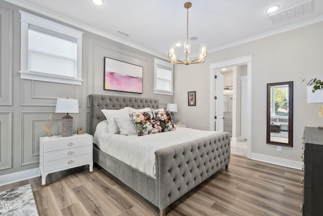 bedroom with ornamental molding, wood finished floors, and visible vents