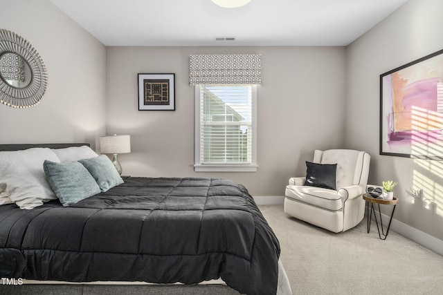 bedroom featuring carpet floors, visible vents, and baseboards