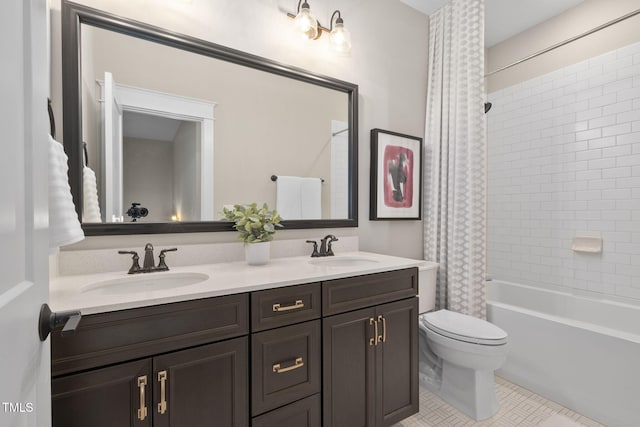 bathroom featuring toilet, tile patterned flooring, double vanity, and a sink