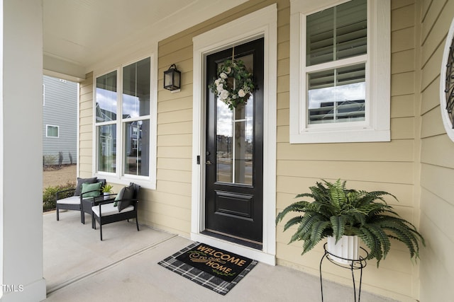 view of exterior entry with a porch