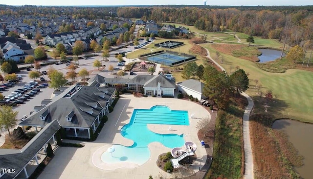 drone / aerial view featuring view of golf course and a water view