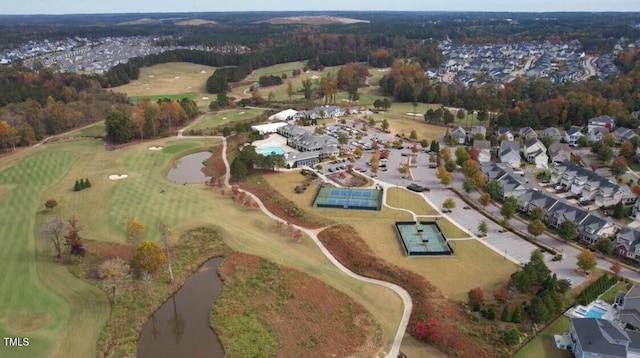 birds eye view of property with view of golf course and a water view