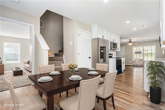 dining space featuring light wood-style flooring, recessed lighting, visible vents, a ceiling fan, and stairway