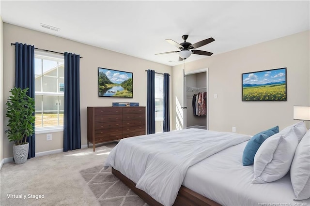 bedroom featuring light colored carpet, multiple windows, and visible vents