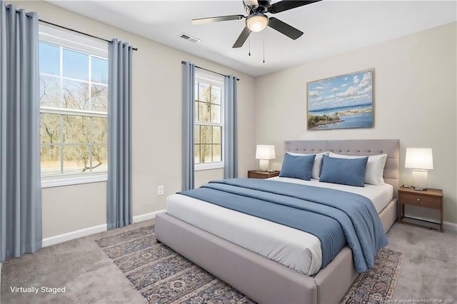 bedroom with baseboards, visible vents, ceiling fan, and light colored carpet