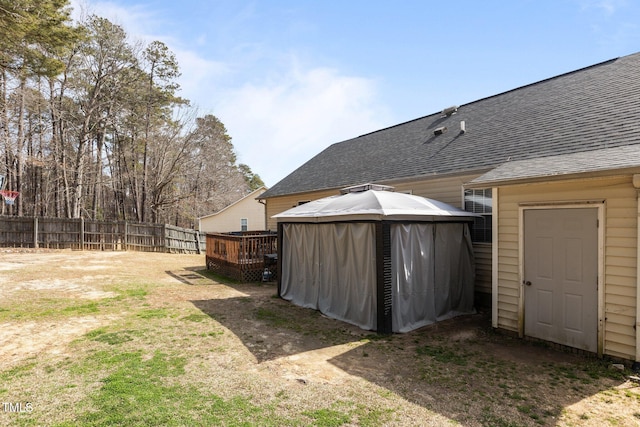 view of yard featuring a gazebo, fence, and a wooden deck