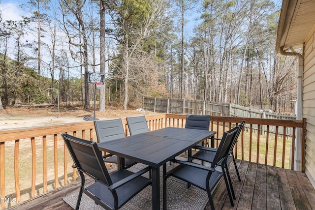 wooden terrace featuring outdoor dining space and fence