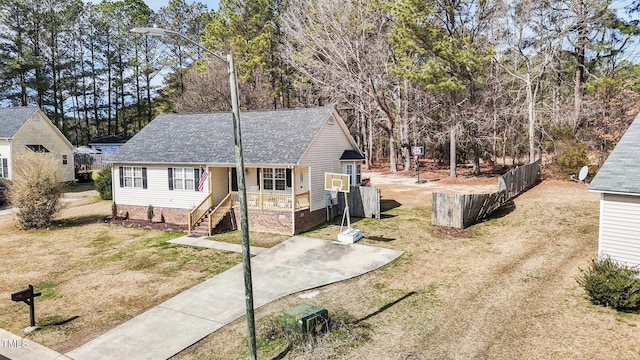 view of front of home with a front yard and a shingled roof