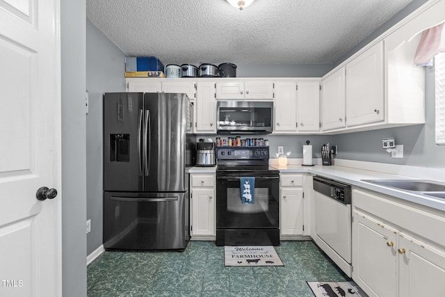 kitchen featuring stainless steel appliances, light countertops, dark floors, and white cabinetry