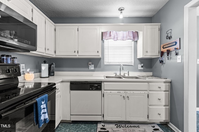 kitchen featuring white cabinetry, a sink, black electric range, dishwasher, and stainless steel microwave