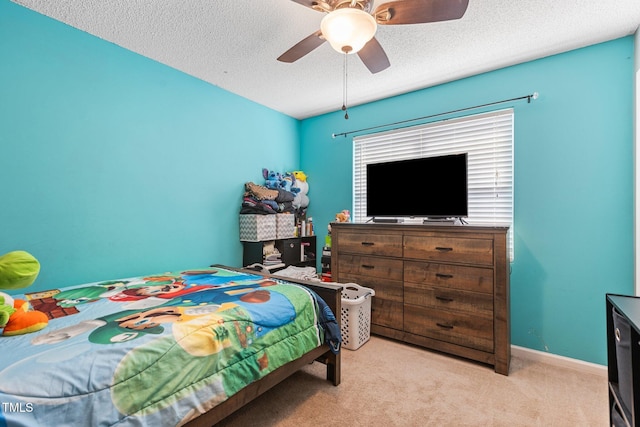 bedroom with a textured ceiling, a ceiling fan, baseboards, and light carpet