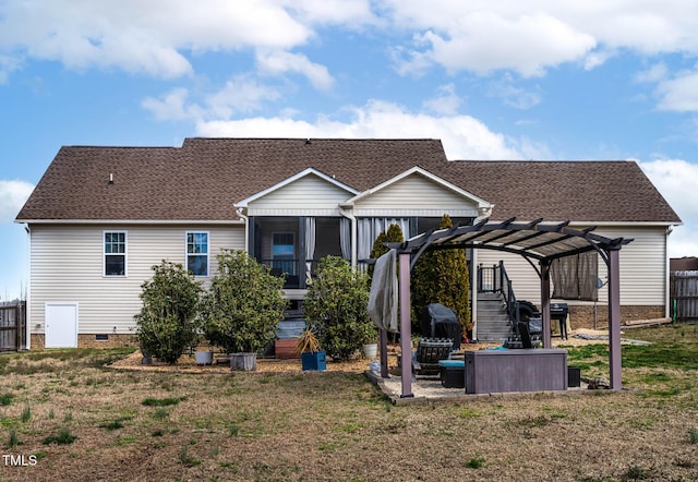 rear view of house featuring crawl space, a lawn, a pergola, and fence