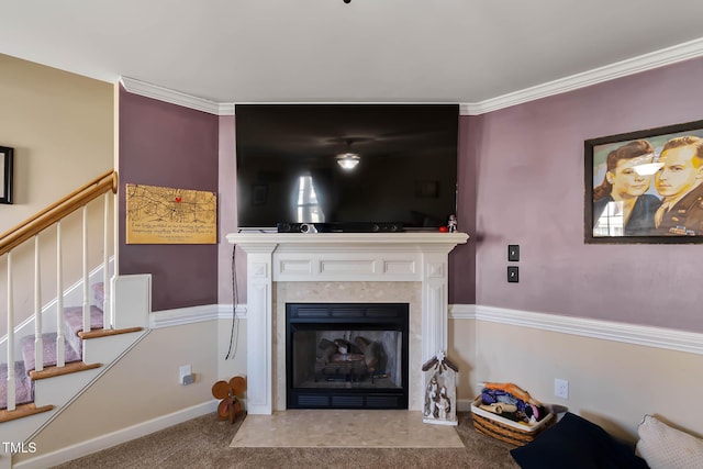 carpeted living area featuring stairs, a fireplace with flush hearth, baseboards, and ornamental molding