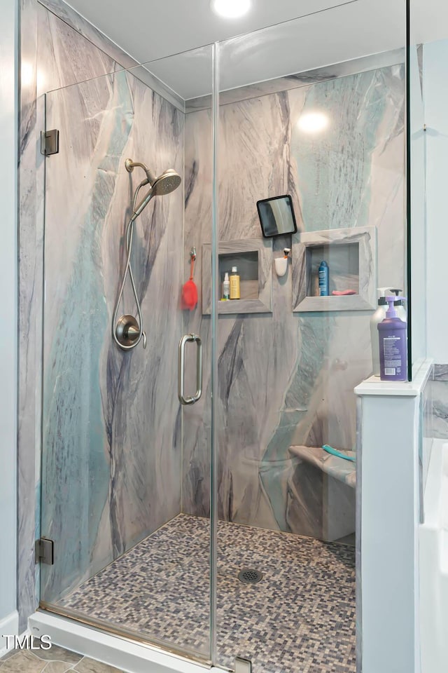 full bathroom featuring a marble finish shower