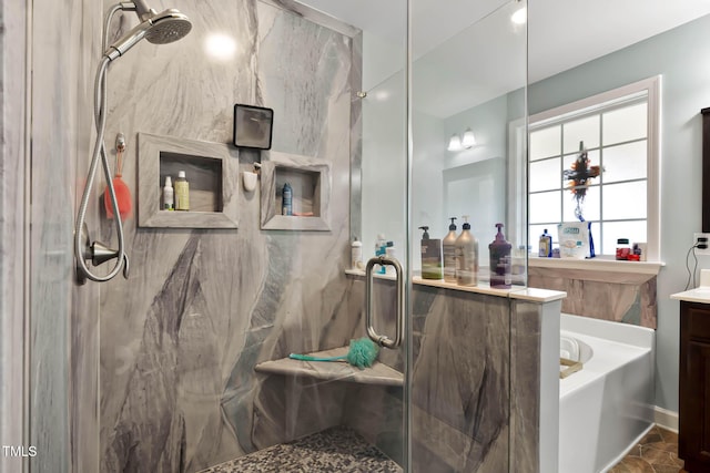 bathroom featuring a marble finish shower, a bath, and vanity