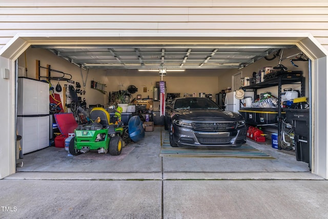 garage featuring driveway and a garage door opener