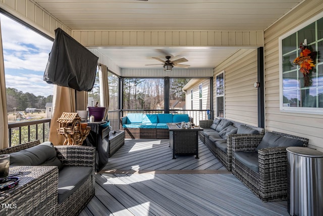 sunroom / solarium featuring a healthy amount of sunlight and a ceiling fan