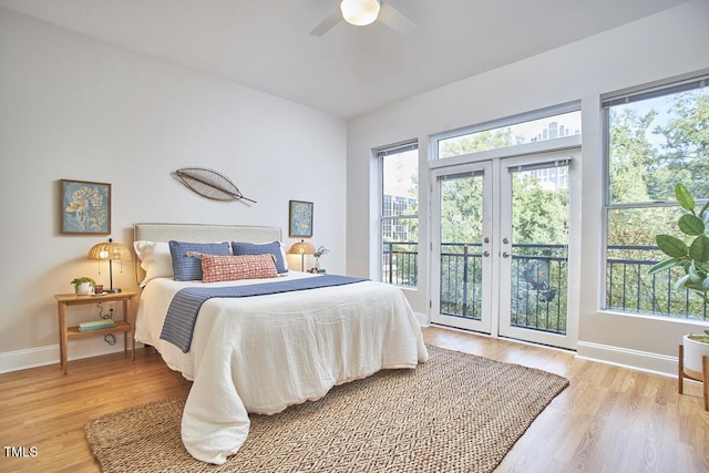 bedroom featuring ceiling fan, wood finished floors, baseboards, access to exterior, and french doors