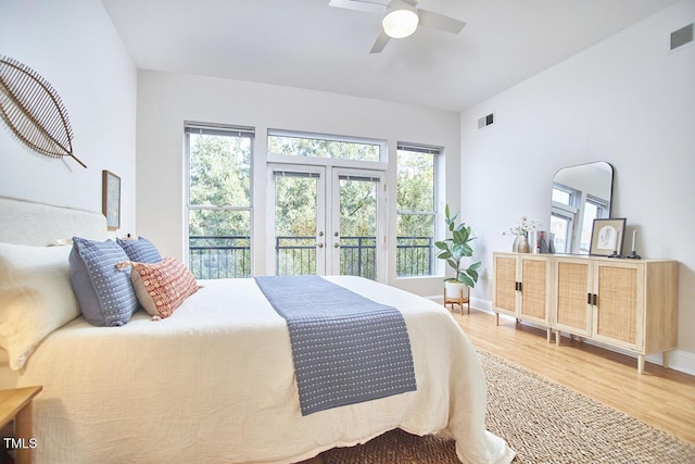 bedroom with baseboards, visible vents, a ceiling fan, light wood-style flooring, and french doors