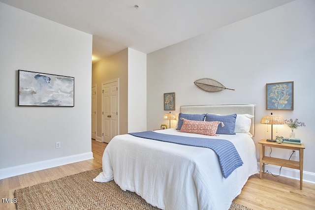 bedroom featuring wood finished floors and baseboards