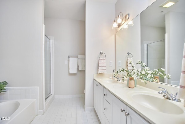 full bathroom with double vanity, a shower stall, a sink, and a bath