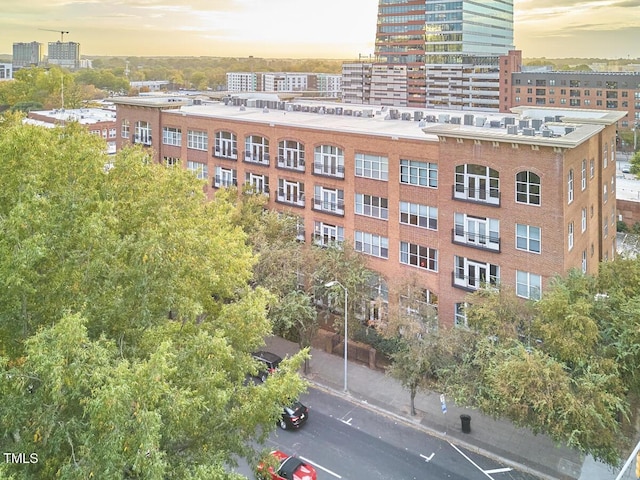 property at dusk featuring a city view