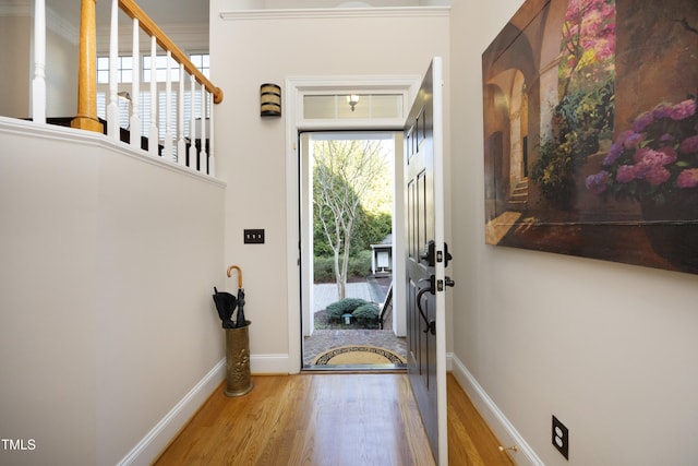 doorway to outside with wood finished floors and baseboards