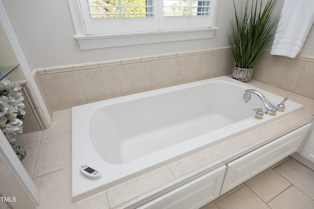 full bath with plenty of natural light, a bath, and tile patterned floors