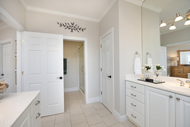 full bathroom with tile patterned floors, a stall shower, crown molding, and vanity