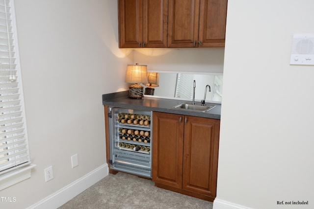 bar with carpet floors, baseboards, and a sink