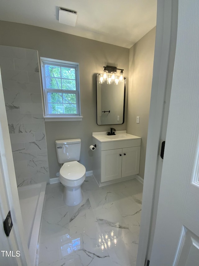 full bathroom featuring a stall shower, baseboards, vanity, toilet, and marble finish floor