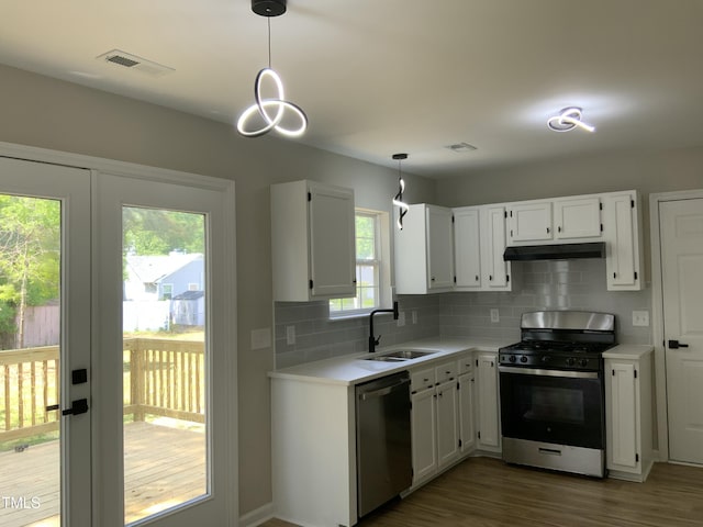 kitchen featuring visible vents, appliances with stainless steel finishes, wood finished floors, a sink, and light countertops