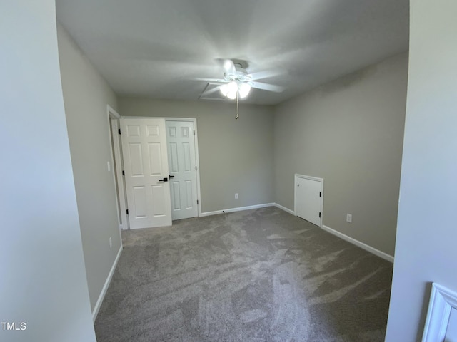 empty room featuring carpet floors, baseboards, and a ceiling fan