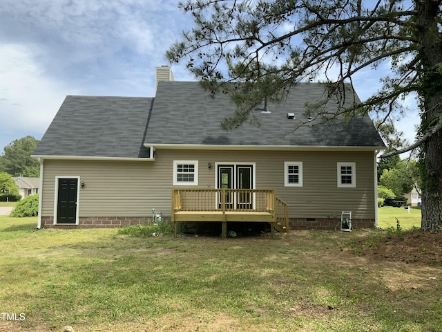 back of property with crawl space, a chimney, a lawn, a wooden deck, and a shingled roof