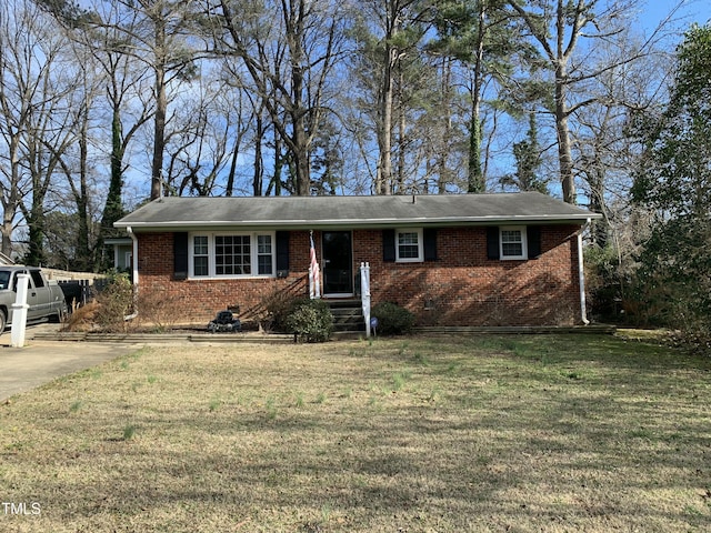 ranch-style home with a front lawn and brick siding