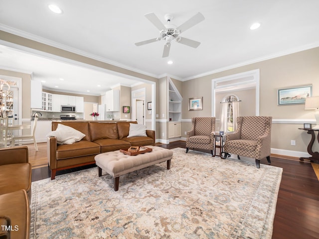 living area with recessed lighting, wood finished floors, baseboards, and ornamental molding