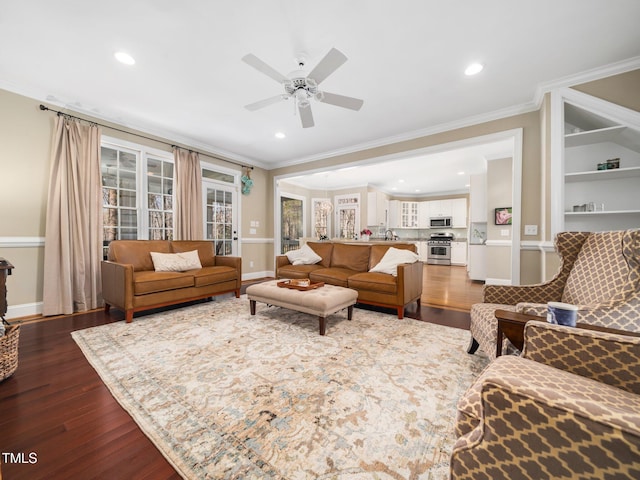 living area featuring recessed lighting, baseboards, dark wood-type flooring, and crown molding