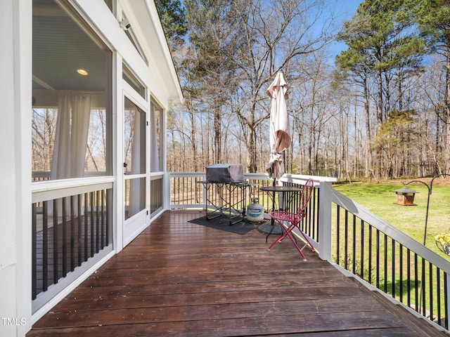 wooden deck with a lawn