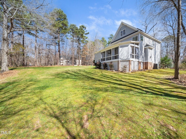 view of home's exterior with a lawn and a sunroom