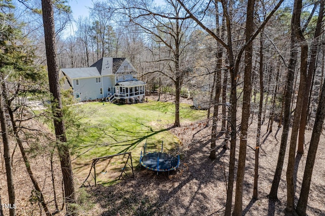 exterior space featuring a lawn and a trampoline