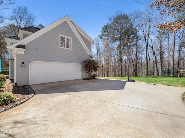 view of property exterior featuring a garage, a lawn, and concrete driveway