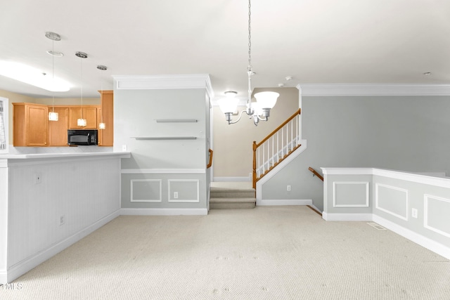 unfurnished room with a decorative wall, ornamental molding, light carpet, a chandelier, and stairs