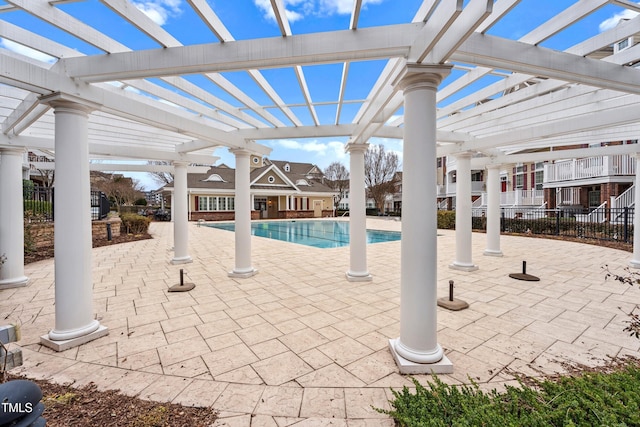 community pool featuring a patio, fence, and a pergola