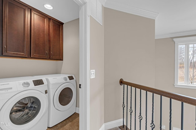 clothes washing area featuring visible vents, baseboards, washer and dryer, ornamental molding, and cabinet space