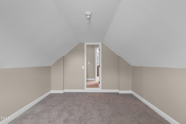 bonus room with carpet floors, vaulted ceiling, and baseboards